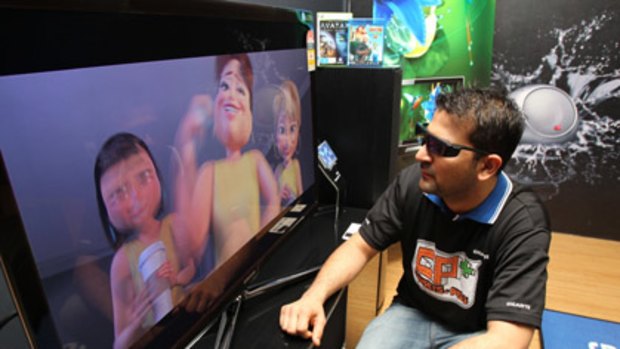 First buyer Vishal Sabhlok, 29, of Chatswood views his new 3D TV.