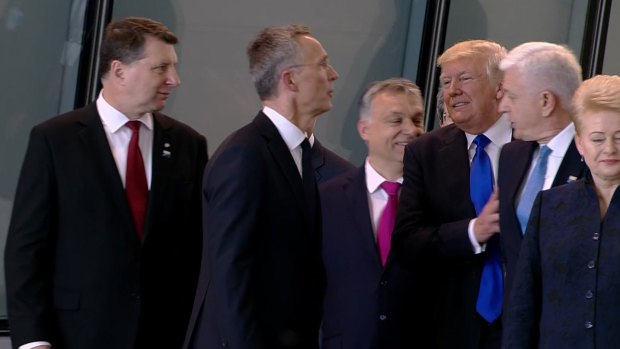 Getting ahead: US President Donald Trump pushes Montenegro Prime Minister Dusko Markovic, second right, at the NATO meeting in Brussels in May.