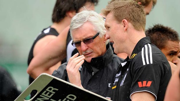 Mick Malthouse and Nathan Buckley confer at quarter-time  yesterday.