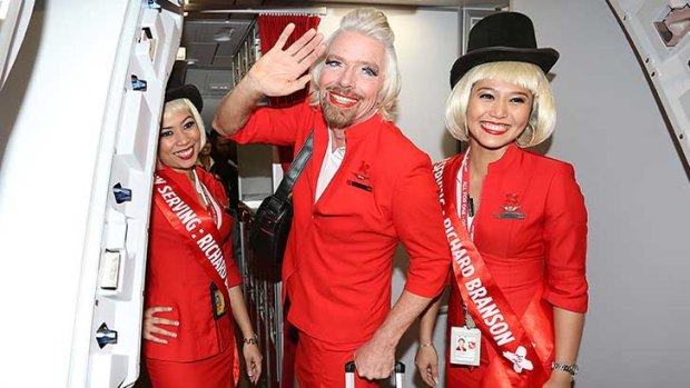 Richard Branson plays hostie for Air Asia after losing a bet.