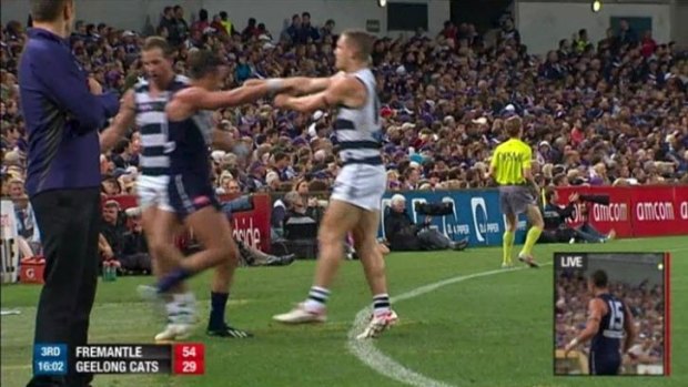 Caught out: Steve Johnson drags Ryan Crowley from the field.