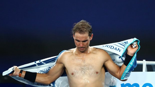 MELBOURNE, AUSTRALIA - JANUARY 23: Rafael Nadal of Spain changes his shirt in his fourth round match against Gael Monfils of France on day eight of the 2017 Australian Open at Melbourne Park on January 23, 2017 in Melbourne, Australia. (Photo by Cameron Spencer/Getty Images)