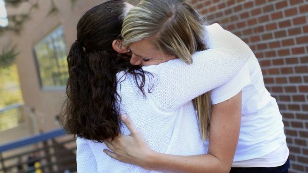 The mother and girlfriend of Alex Teves hug outside court.