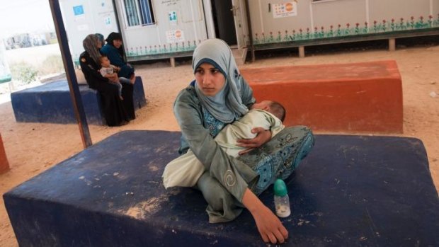 Hana Moham­med, 16, whose seizu­res began durin­g pregn­ancy, waits to see a docto­r in the Zaata­ri camp, Jordan.