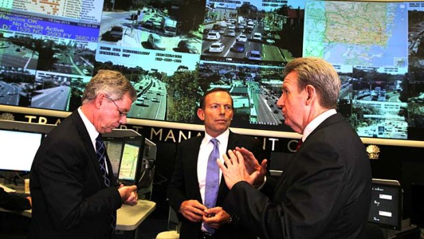WestConnex contracts: Premier Barry O'Farrell, right, with Prime Minister Tony Abbott and Traffic Management Centre's Phil Akers discussing the WestConnex project.