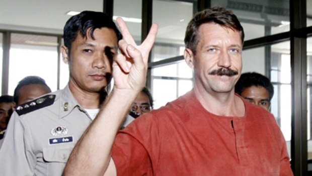 V for temporary victory ... suspected Russian arms dealer Viktor Bout leaves a courtroom in Bangkok.