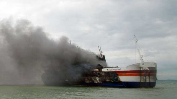 Smoke billows from the burning ferry off Merak yesterday. Some passengers blamed a cigarette butt for the blaze.