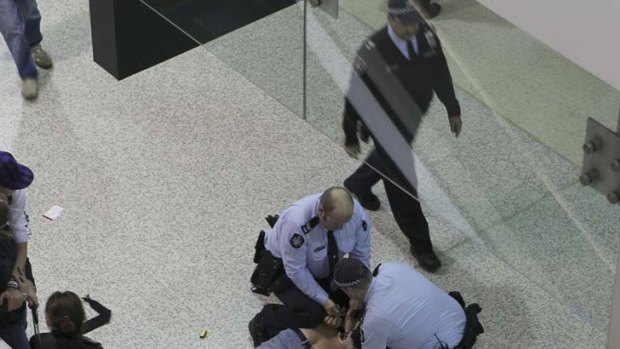 Federal Police pounce on a disgruntled passenger at Tullamarine airport last night after weather chaos caused the cancellation of flights and long delays.