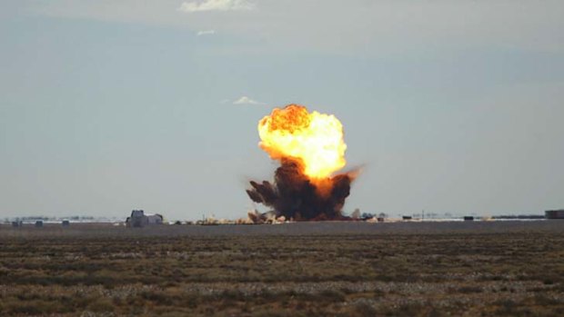 A bomb explodes at the Woomera rocket range.