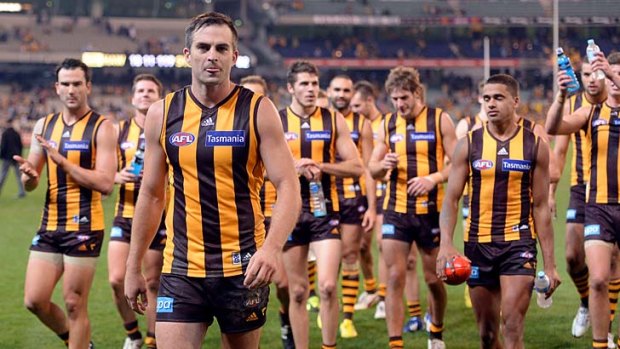 Hawthorn's Brian Lake leads the team in after it defeated Sydney at the MCG.