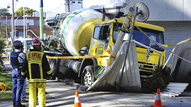 A cement truck causes a swathe of destruction at a petrol station on the Pacific Highway at Chatswood today.