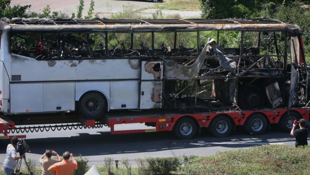 A damaged bus is transported out of Burgas airport, Bulgaria, a day after a Hezbollah suicide attack on a bus full of Israeli vacationers.