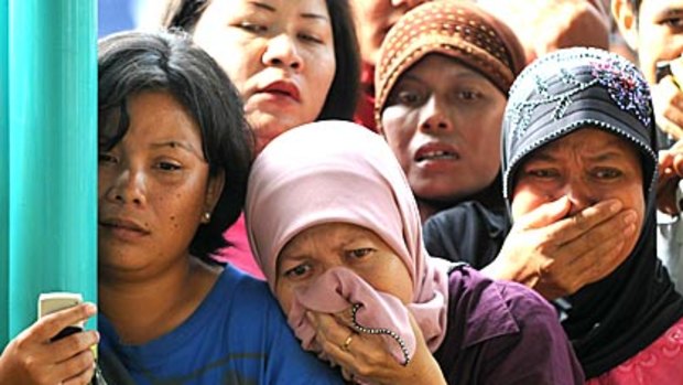 Family members recognise dead relatives at a Padang hospital yesterday.