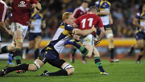 Brumbies player Peter Kimlin tackles  Lions player Shane Williams.