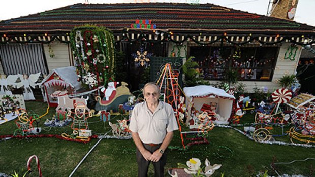 "People drive by and say my place is lit up like a fairy park." Bob Langley stands among his festive season creations outside his house in Ibottson Street, Watsonia.