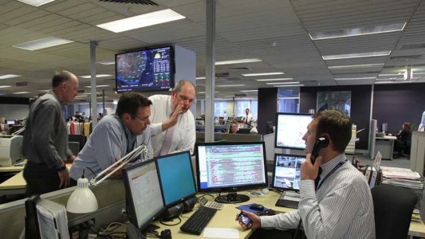 Back on track ... the Qantas control room in Mascot works to get flights going again yesterday after Fair Work Australia ordered the airline and three unions to enter negotiations.