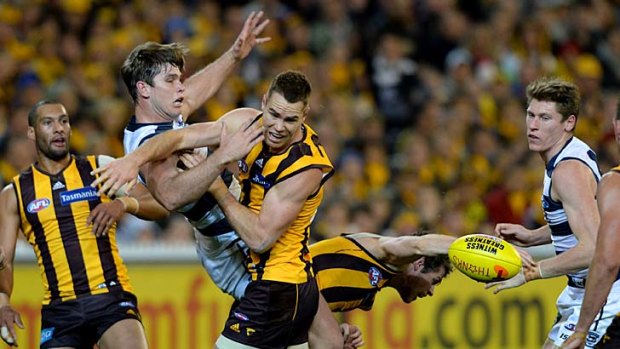 Hawthorn's Max Bailey and Geelong's Tom Hawkins battle for a mark.