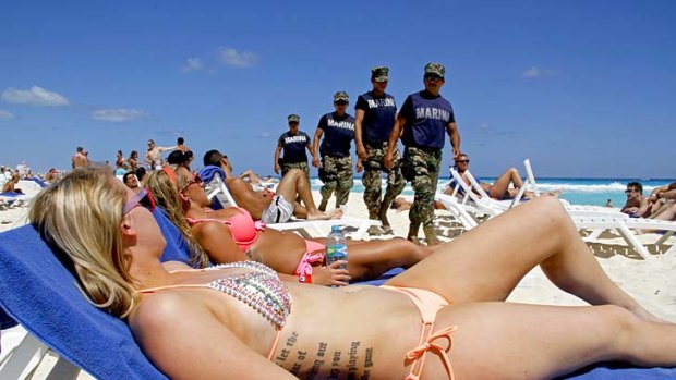 Navy sailors patrol the beach during spring break in Cancun, Mexico.