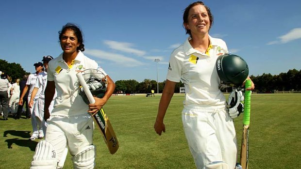 Winners are grinners: Sarah Elliott (right) and Lisa Sthalekar walk off after Australia's Test win over England in Sydney in 2011.
