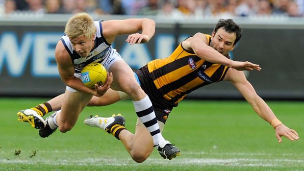 Geelong's George Horlin-Smith clashes with Hawthorn's Jordan Lewis at the MCG in round one this year. The Hawks lost by seven points.