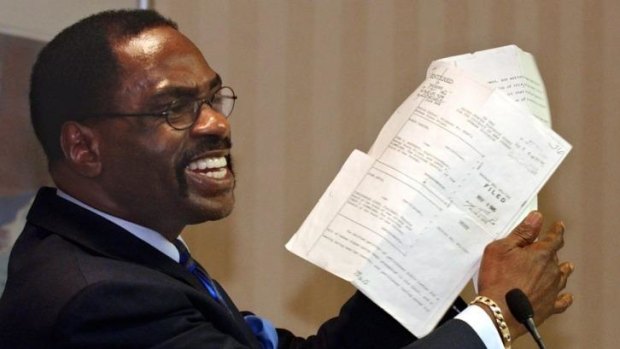 Rubin "Hurricane" Carter holds up the writ of habeas corpus that freed him from prison, during a news conference in California in 2004.