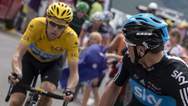 Usurped: Bradley Wiggins has taken a back seat to teammate Christopher Froome pictured waiting for his former team leader in last year's Tour de France.
