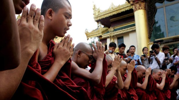 Buddhist monks pray in Rangoon over killings in the state of Rakhine, where authorities are trying to prevent the spread of violence between local Buddhists and Muslims.