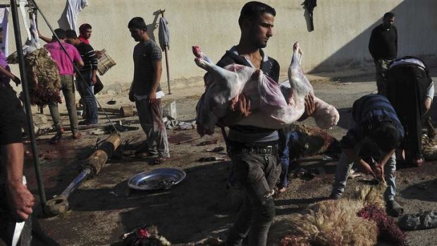 Sheep are slaughtered on the first day of Eid al-Adha in Raqqa, eastern Syria.