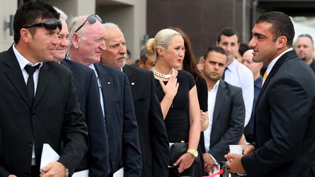 Farewell ... Tim Mannah, right, talks to fellow mourners at his brother Jon's funeral in Auburn on Monday.