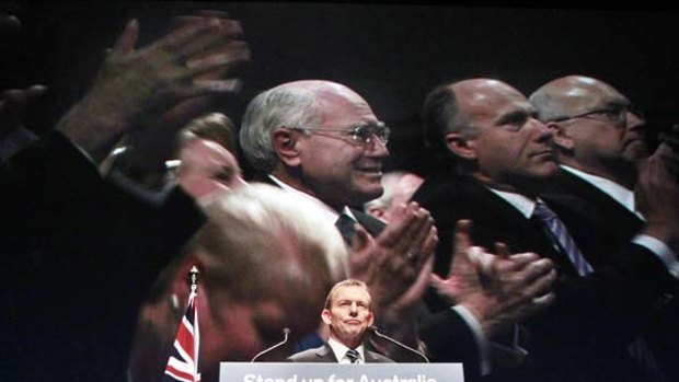Standing up for Abbott ... among those applauding the Liberal leader  at the  party’s   campaign launch yesterday was former prime minister John Howard.