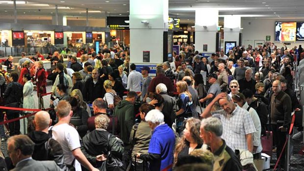 Qantas passengers queue at the Virgin check-in at Melbourne Airport as they try to get tickets home.