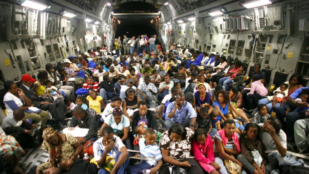 Outward bound ... evacuees on a US C-17 Globemaster aircraft at Port-au-Prince airport. They were flown to Orlando, Florida.