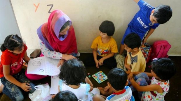 Welcome distraction: Children learning English at the centre. 