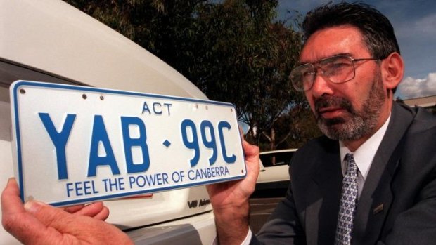 Road User Services manager Kerry Kennedy with a ‘Feel the Power of Canberra’ number plate in 1998.
