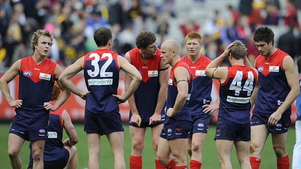 Under pressure: Demons players after the 2009 defeat against Richmond.