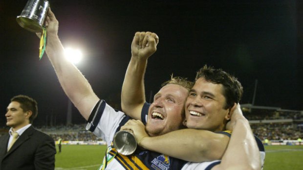 Bill Young, left, celebrates the Brumbies' 2004 Super Rugby title with Jeremy Paul.