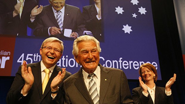Standing ovation ... Bob Hawke takes to the stage, applauded by Prime Minister Kevin Rudd and Deputy PM Julia Gillard.