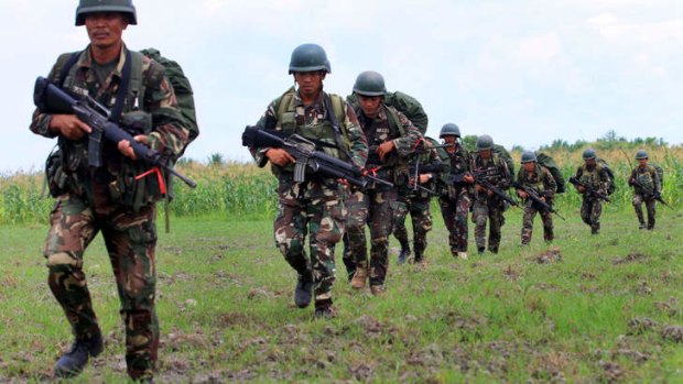 Philippine soldiers patrol a rice field during in the Maguindanao province.