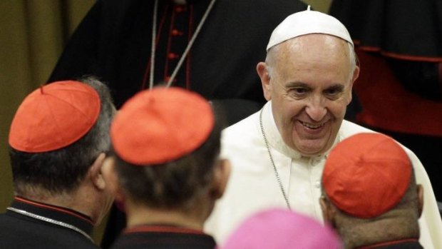Compassionate leader: Pope Francis smiles as he talks to cardinals during the synod of bishops.