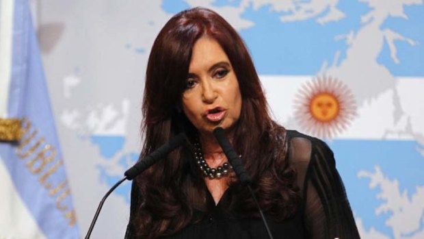Not happy ... Cristina Kirchner takes aim at Britain, a map of the Falklands at her shoulder. Photo: Reuters