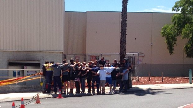 Workmates of Matt Hutchins pay their respects at the Galleria.