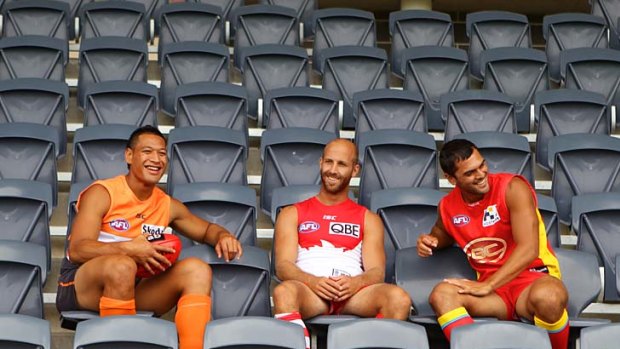 Israel Folau, Jarrad McVeigh and Karmichael Hunt share a laugh at Rooty Hill stadium last month.