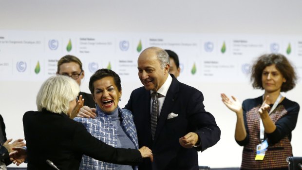 French Foreign Minister Laurent Fabius celebrates with United Nations climate chief Christiana Figueres after a climate deal is secured in Paris.