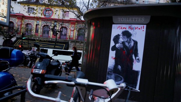 A poster of wounded lovers stating "Not even hurt" opposite the Bataclan concert hall.