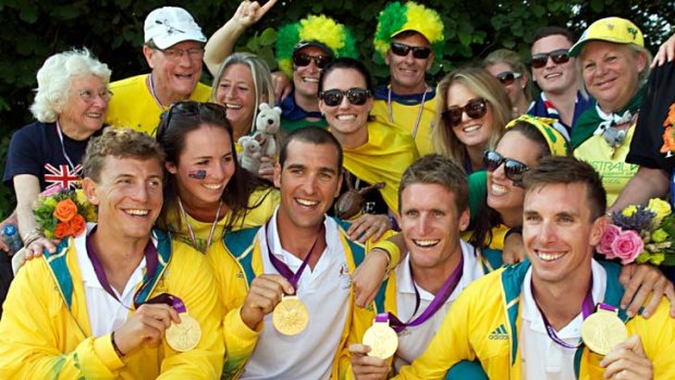 Australia's Tate Smith , Dave Smith and Murray Stewart and Jacob Clear get mobbed by their families after winning gold.