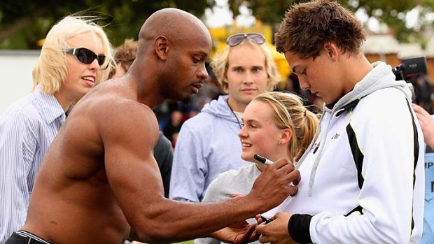 Asafa Powell signs autographs for fans in Stawell.