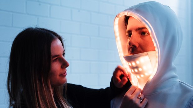 Textile designer Lillian Hambling with a friend modelling her wearable technology garment, e-motion, to create a new form of non-verbal communication for males by measuring physiological data from the body and expressing it as dynamic light displays. 