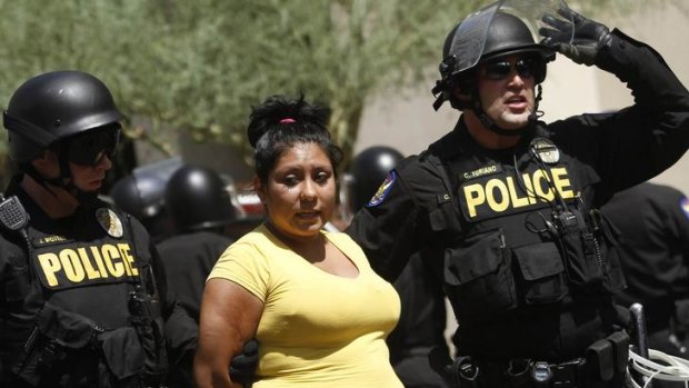 A demonstrator is arrested during a protest against Arizona's controversial Senate Bill 1070 immigration law outside Sheriff Joe Arpaio's office.