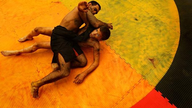New life: Shane Parker (left) and Blaike O'Neill demonstrate the traditional Aboriginal form of wrestling.
