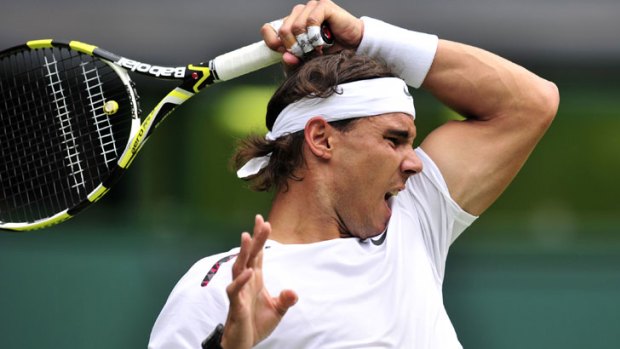 Rafael Nadal hits a forehand in his first-round win over Brazil's Thomaz Bellucci at Wimbledon.